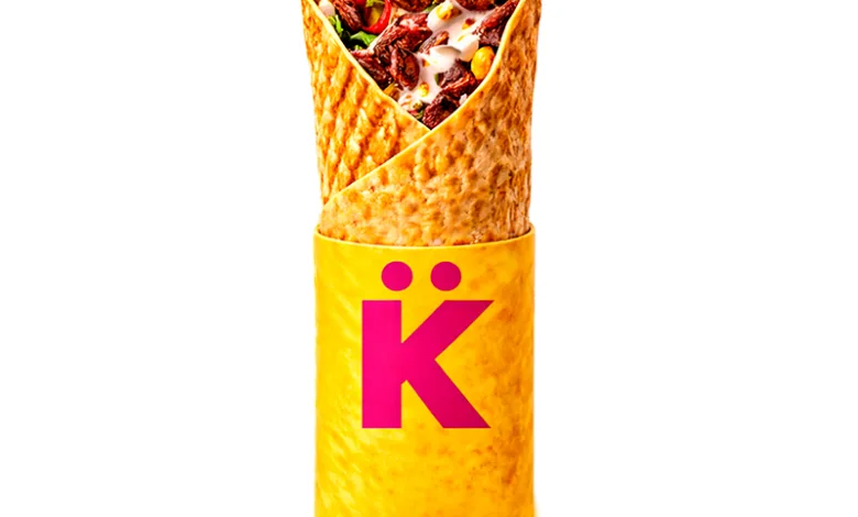 Beef-filled wrap upright in a yellow wrapper with a pink K logo.
