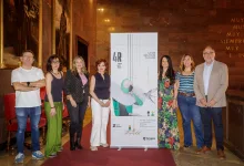Eight Adults Stand on a Red Carpet Beside a Tall Promotional Banner for an Event 4r Mayjuly 2026 in a Marble walled Venue Zaragoza Qué Hacer En Zaragoza Zaragozala Qué Hacer En Zaragoza