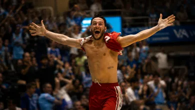 Male Athlete in Red Shorts Celebrates with Arms Raised in a Packed Arena Crowd Behind Him Shirtless and Triumphant Casademont Zaragoza Salva La Categoría En El último Segundo Zaragozala   Qué Hacer En Zaragoza