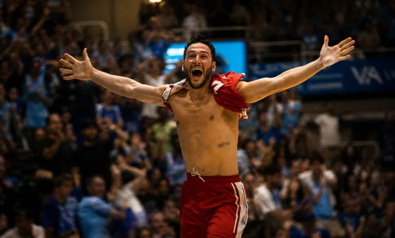 Male Athlete in Red Shorts Celebrates with Arms Raised in a Packed Arena Crowd Behind Him Shirtless and Triumphant Casademont Zaragoza Salva La Categoría En El último Segundo Zaragozala Qué Hacer En Zaragoza