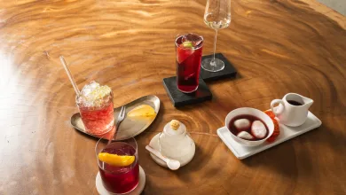 Assorted Desserts and Drinks on a Polished Wooden Table Red Cocktails a Sparkling Crushed ice Drink and a White Creamer Alongside a Small Dessert Tray with Mochi Balls Cariñena Spritz Este Fin De Semana En Plaza De Los Sitios Zaragozala   Qué Hacer En Zaragoza