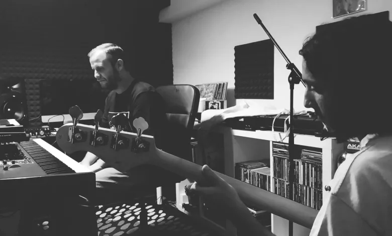 Two Musicians in a Home Studio One at a Keyboard and a Bassist in the Foreground Both Focused on Their Instruments in Monochrome Ricardo Y Botigué En El Festival Nem En Zaragoza Zaragozala Qué Hacer En Zaragoza