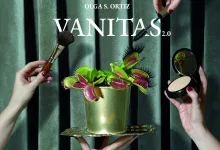 Promotional image for Vanitas 2.0 by Olga S. Ortiz: hands hold makeup brushes around a green Venus flytrap in a gold pot against velvet backdrop.