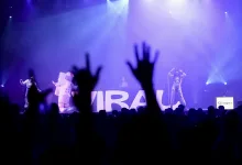 Concert Stage with Performers in Space themed Costumes Under Blue purple Lights Audience Hands Raised in the Foreground Large Letters on Backdrop Zaragoza Signage Visible Zaragozala | Agenda Cultural Ocio Y Planes En Zaragoza Zaragozala   Qué Hacer En Zaragoza