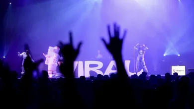 Concert Stage with Performers in Space themed Costumes Under Blue purple Lights Audience Hands Raised in the Foreground Large Letters on Backdrop Zaragoza Signage Visible Zaragozala | Agenda Cultural Ocio Y Planes En Zaragoza Zaragozala   Qué Hacer En Zaragoza