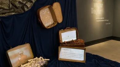 Exhibit with Vintage Suitcases Opened to Reveal Rolled Documents and a Photo Inside Arranged on Dark Blue Fabric Zaragozala | Agenda Cultural Ocio Y Planes En Zaragoza Zaragozala   Qué Hacer En Zaragoza