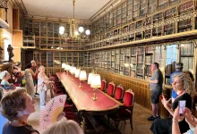 Tourists in a Grand Historic Library with a Long Redtable Brass Lamps and Gilded Glass front Bookcases Lining the Walls Zaragozala | Agenda Cultural Ocio Y Planes En Zaragoza Zaragozala   Qué Hacer En Zaragoza