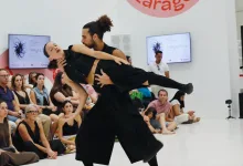 Duo of Dancers Performing a Lifted Pose on a White Stage Audience Seated Behind Watching Intently Trayectos Llena Azucarera En Su Primera Jornada De Danza Zaragozala   Qué Hacer En Zaragoza