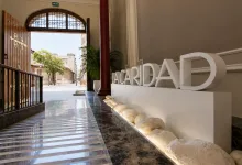 Indoor Lobby with Large White acardad Letters on a Pedestal Beside a Marble Floor and Open Wooden Doors to a Sunlit Street Zaragozala | Agenda Cultural Ocio Y Planes En Zaragoza Zaragozala Qué Hacer En Zaragoza