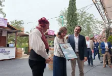 Woman in Traditional Dress Receives a Framed Certificate from Two Men at a Wine Festival with String Lights and Stalls in the Background Zaragozala | Agenda Cultural Ocio Y Planes En Zaragoza Zaragozala   Qué Hacer En Zaragoza