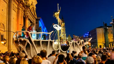 Nighttime Parade Float Shaped Like White Bones Atop a Large Cart Crowd Filming and Watching in a Lit Urban Square Zaragozala | Agenda Cultural Ocio Y Planes En Zaragoza Zaragozala   Qué Hacer En Zaragoza