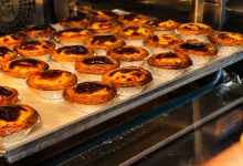 Rows of Golden Custard Tarts on a Baking Tray Inside an Industrial Oven Pasteles De Nata Abre Natas Douro En Zaragoza Zaragozala   Qué Hacer En Zaragoza