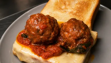 Two Meatballs in Tomato Sauce Resting on Melted Cheese Atop a Slice of Toasted Bread with a Second Toasted Slice on the Plate Los Auténticos Sándwiches De Nueva York Aterrizan En Zaragoza Zaragozala Qué Hacer En Zaragoza