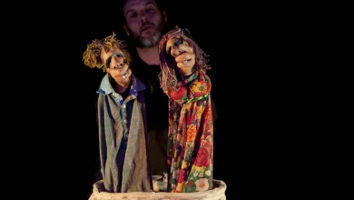 Puppeteer Holds Two Handmade Puppets with Yarn Hair in Front of a Dark Background Performing a Puppet Show Harinera Zgz Inicia Su Programación De Verano Zaragozala   Qué Hacer En Zaragoza