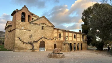 Stone Historic Church with Bell Tower and Arched Colonnade in a Sunlit Plaza Vine covered Wall Along the Facade Sonna Huesca 2026 Conciertos Del 31 De Julio Zaragozala Qué Hacer En Zaragoza