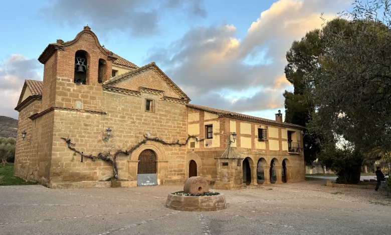 Stone Historic Church with Bell Tower and Arched Colonnade in a Sunlit Plaza Vine covered Wall Along the Facade Sonna Huesca 2026 Conciertos Del 31 De Julio Zaragozala Qué Hacer En Zaragoza