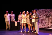 Eight Young Performers Stand in a Line on Stage Smiling a Table with a Polka dot Cloth and a Large Illustrated Backdrop Behind Them Zaragozala | Agenda Cultural Ocio Y Planes En Zaragoza Zaragozala Qué Hacer En Zaragoza