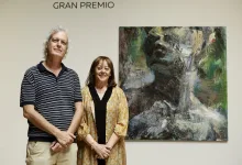 Man and Woman Stand Side by Side in a Gallery Posing in Front of a Large Abstract Painting As the Word gran Premio Appears on the Wall Above Themy Zaragozala | Agenda Cultural Ocio Y Planes En Zaragoza Zaragozala Qué Hacer En Zaragoza