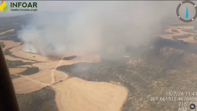 Aerial View of a Wildfire with Smoke Rising over Beige Fields and Winding Dirt Roads Seen from a Helicopter Infoar Logo in Corner Incendio De Orés Evacuados 3 Pueblos Y Activado El Nivel 2 Zaragozala Qué Hacer En Zaragoza