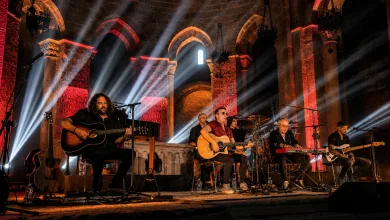 Live Band Performing on a Historic Stone arched Stage Bathed in Red and White Spotlight Beams Tako Repasa Cuatro Décadas De Historia En Un Veruela Lleno Zaragozala   Qué Hacer En Zaragoza