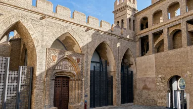 Stone Fortress with Arched Entrance and Crenellated Walls Under a Blue Sky Medieval Brickwork and Decorative Doorway Front Center Zaragozala | Agenda Cultural Ocio Y Planes En Zaragoza Zaragozala   Qué Hacer En Zaragoza