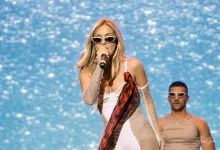 Female Pop Singer on Stage Wearing White Bodysuit and Mesh Sleeves Singing into a Microphone with a Blue Water like Backdrop Ana Mena En Zaragoza 2026 Concierto En Espacio Zity Zaragozala   Qué Hacer En Zaragoza