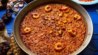 Pan of Seafood Paella with Shrimp Scattered over Saffron tried Rice in a Large Skillet on a Blue Table Surface Zaragozala | Agenda Cultural Ocio Y Planes En Zaragoza Zaragozala   Qué Hacer En Zaragoza