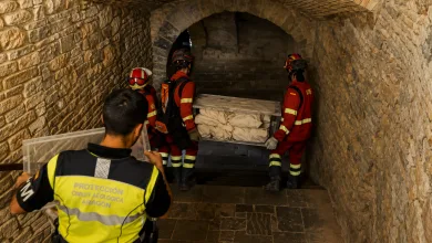 Emergency Responders in Red Uniforms Carry a Coffin Covered with White Cloths Down a Stone walled Tunnel with an Arched Ceiling Aragón Evacúa Los Bienes De San Juan De La Peña Zaragozala   Qué Hacer En Zaragoza