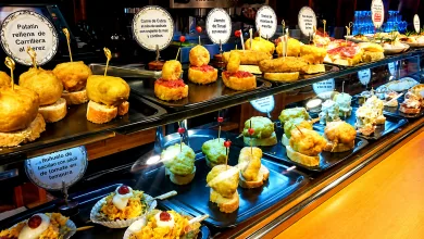 Buffet style Display of Bite sized Tapas and Croquettes on Metal Trays with Round Label Signs in Spanish Flash Alagón Tapas Originales Cerca De Zaragoza Zaragozala Qué Hacer En Zaragoza
