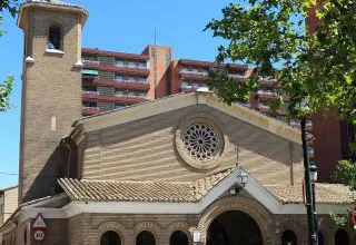 Stone Church with a Circular Rose Window and Arched Entry Flanked by a Small Bell Tower on the Left on a Tree lined Urban Street Zaragozala | Agenda Cultural Ocio Y Planes En Zaragoza Zaragozala   Qué Hacer En Zaragoza