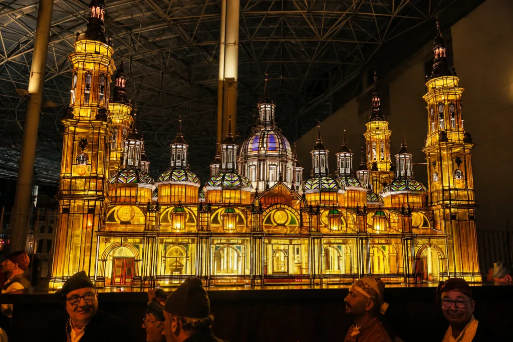 Illuminated Ornate Cathedral Model on Display with Golden Glow and Visitors in the Foreground Museo Del Rosario De Cristal De Zaragoza Visita Y Horario Zaragozala   Qué Hacer En Zaragoza