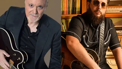 Two Men with Guitars Split by a Vertical Divider Left Bald Man in a Black Suit Right Bearded Man Wearing Sunglasses and a Black Shirt in a Home Studio Gabriel Sopeña Y Jj Fuentes Estrenan ay Girasol Zaragozala Qué Hacer En Zaragoza