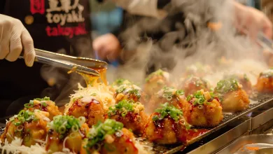Chef in Gloves Plates Takoyaki on a Hot Griddle Sauce and Toppings Steaming Up the Scene Street Food En Zaragoza Talleres De Cocina Del Mundo Zaragozala Qué Hacer En Zaragoza